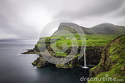 Gasadalur village and its iconic waterfall, Vagar, Faroe Islands, Denmark. Long exposure. Stock Photo