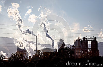 Gases steam and smoke coming from industrial site Stock Photo