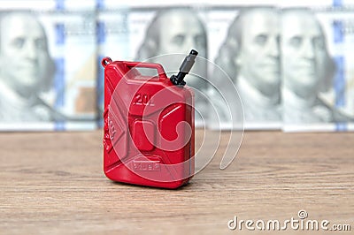 Gasoline barrel in front of dollar banknotes background Stock Photo