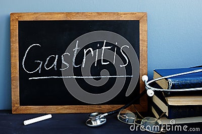 Gastritis written on a blackboard in a hospital. Stock Photo