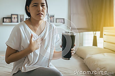 Asian woman having or symptomatic reflux acids Stock Photo