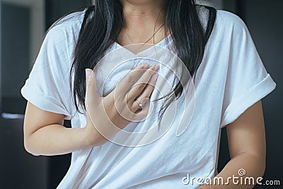 Asian woman having or symptomatic reflux acids Stock Photo