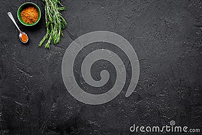 Gastronomy, culinary. Secrets of tasty dishes. Seasoning and spices. Ground spices, rosemary on black background top Stock Photo