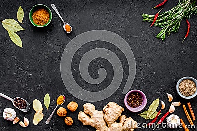 Gastronomy, culinary. Secrets of tasty dishes. Seasoning and spices. Rosemary, ginger, chili pepper on black background Stock Photo