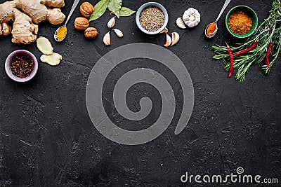 Gastronomy, culinary. Secrets of tasty dishes. Seasoning and spices. Rosemary, ginger, chili pepper on black background Stock Photo