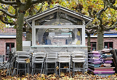 Gastronomy lockdown, closed restaurant terrace, beer garden due to corona epidemic, chairs and tables stacked Stock Photo