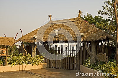 Gated entrance with thatch roof Stock Photo