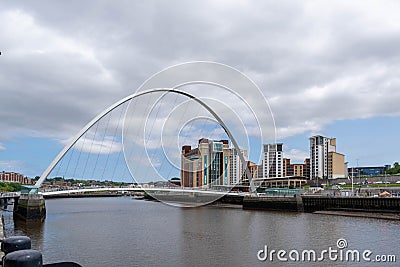 Gateshead Millennium Bridge is a pedestrian and cyclist tilt bridge spanning the River Tyne Editorial Stock Photo