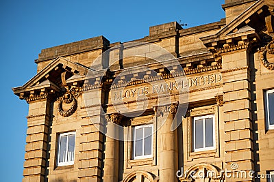 Impressive architecture of a fomer Lloyds Bank with golden lettering on exterior Editorial Stock Photo