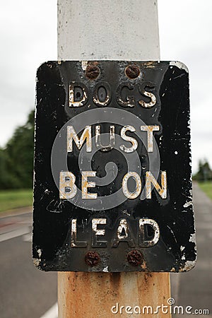 Dogs Must Be On Lead retro rusted sign Editorial Stock Photo