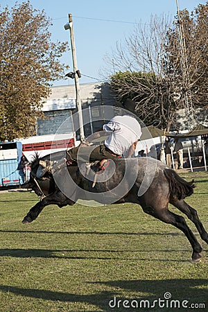 Gaucho cowboy Vaquero at a rodeo riding a horse at a show in Argentina Stock Photo