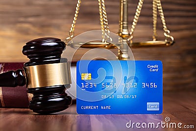 Gavel And Blue Credit Card On Wooden Table Stock Photo