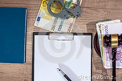 Gavel,handcuffs and euro money with empty notepad on desk. Stock Photo