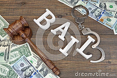 Gavel, Sign BAIL, Handcuffs And Dollar Cash On Wood Background Stock Photo
