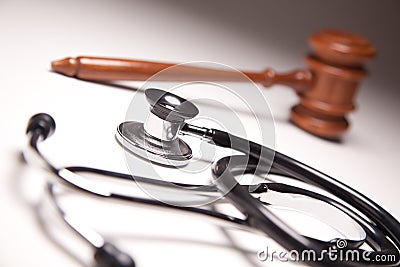 Gavel and Stethoscope on Gradated Background Stock Photo