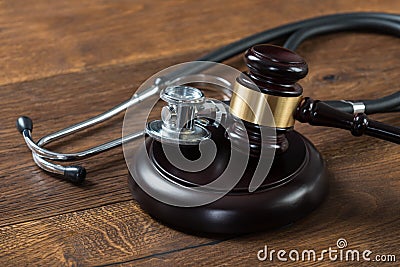 Gavel And Stethoscope On Table Stock Photo