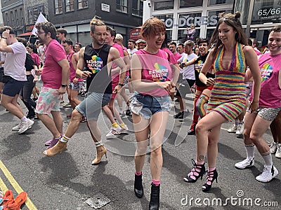 Gay activists dancing with LGBT flags at the Pride parade in London , England 2023 Editorial Stock Photo