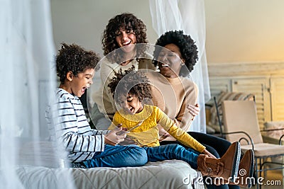 Gay couple children love happiness concept. Happy multiethnic family spending time together at home Stock Photo