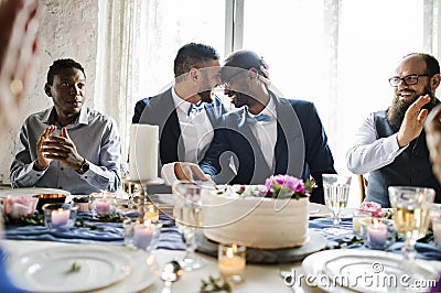 Gay Couple Hands Cutting Wedding Cake Stock Photo