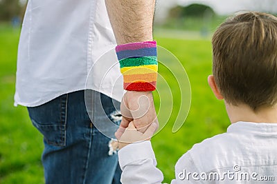 Gay father holding his son`s hand in a park. Parental concept and equality Stock Photo