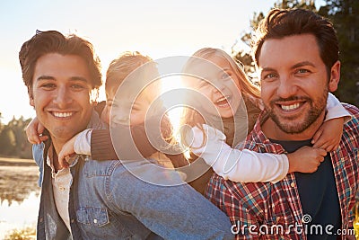 Gay Male Couple With Children Walking By Lake Stock Photo