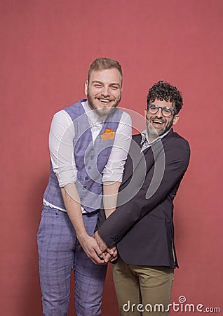 Gay men acting silly, holding hands together Stock Photo