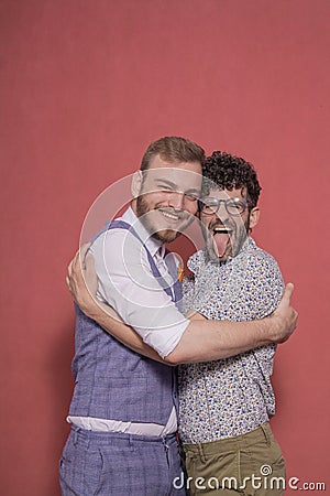Gay men acting silly, hugging together Stock Photo