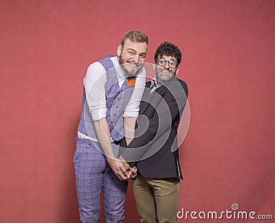 Gay men acting silly, hugging together Stock Photo