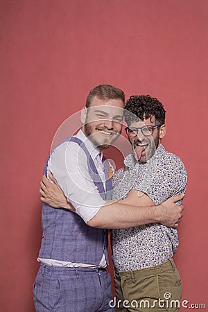 Gay men acting silly, hugging together Stock Photo