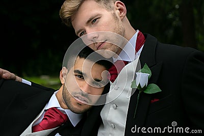 Gay weddings, grooms, couples pose for pictures after their wedding ceremony in churchyard Stock Photo