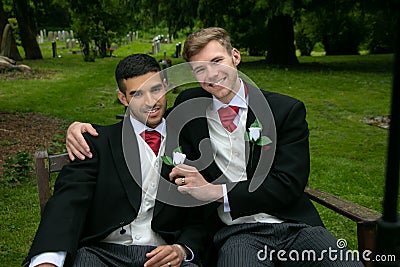 Gay weddings, grooms, couples pose for pictures after their wedding ceremony in churchyard Stock Photo