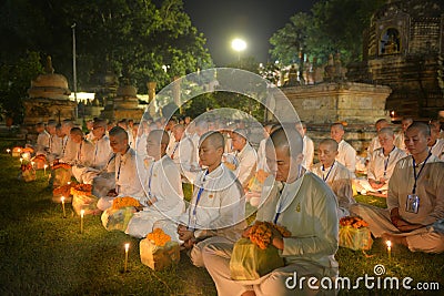 Group of practitioners meditation sitting meditate with candle in Mahabodhi temple ,Bodh Gaya ,Bihar at night Editorial Stock Photo