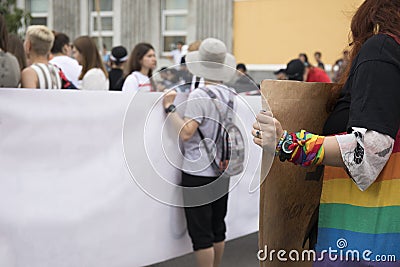 GayPride spectators carrying banners with copy space during Pride parade. Rainbow colors cloth Editorial Stock Photo