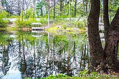 Gazebo. The lake reflects forest trees Stock Photo