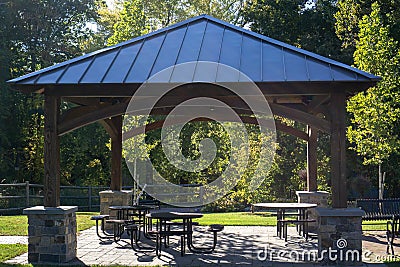 Gazebo or pavilion in a park with some seating and tables providing shade and rest Stock Photo