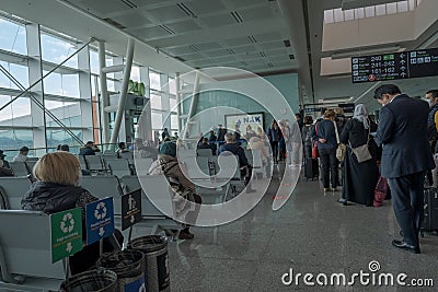 Passengers wait for their turn come to get in the plane in front of airplane gate in Aydin Menderes Airport Editorial Stock Photo