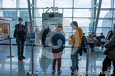 Gaziemir, Izmir, Turkey - 03.11.2021: people with mask waiting in front of flight gate in Aydin Menderes Airport in quarantine Editorial Stock Photo