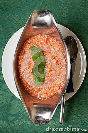 Gazpacho soup garnished with basil leaves Stock Photo