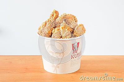 A lots of KFC chicken hot wings in bucket of KFC Kentucky Fried Chicken fast food. Editorial Stock Photo