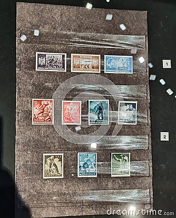 GDANSK, POLAND: Old postal stamps from different European countries during world war II time on the wall Editorial Stock Photo