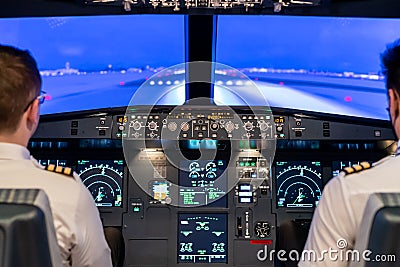 Simulator of a passenger aircraft with a cockpit and pilots Editorial Stock Photo