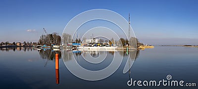 Gdansk, Pomeranian Poland - March, 10, 2021: View of the buildings and cranes of the shipyard building the ships. Industrial Editorial Stock Photo