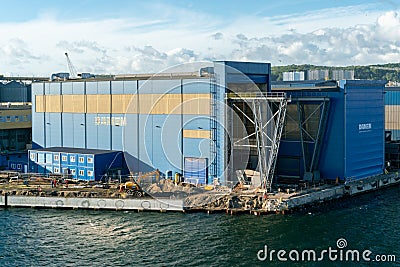 Gdynia, Poland - 09.23.2021: Huge Damen warehouse building in port by the sea. Editorial Stock Photo