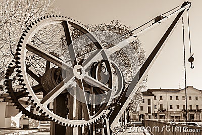 Gear wheels of an old and vintage crane, on lake Maggiore, Italy Stock Photo