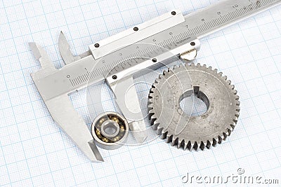 Gears and caliper on graph paper Stock Photo