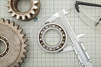 Gears and caliper on graph paper Stock Photo