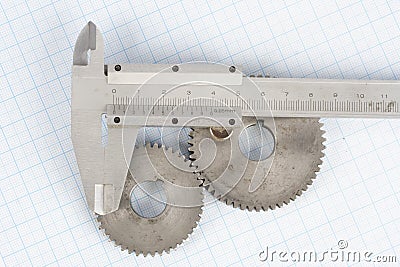 Gears and caliper on graph paper Stock Photo