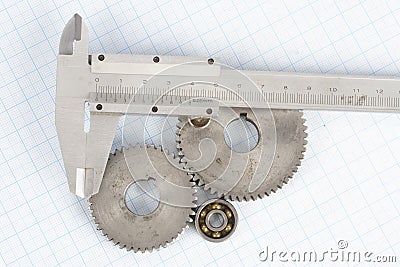 Gears and caliper on graph paper Stock Photo