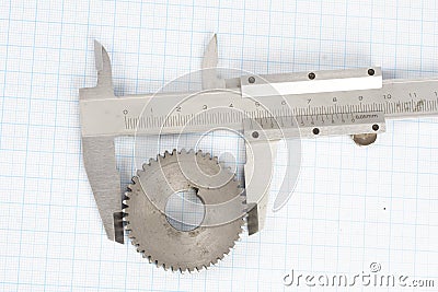 Gears and caliper on graph paper Stock Photo