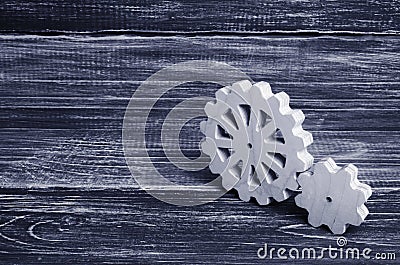 Gears of wood stand on a dark wooden background. Concept of tech Stock Photo